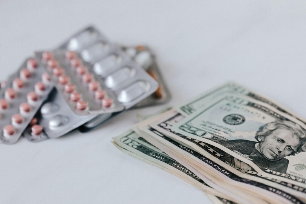 Close-up of pills and cash representing healthcare expenses and medication costs.